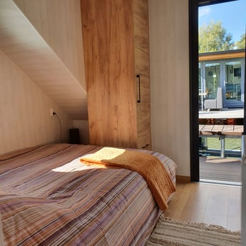 View of the main bedroom looking at the rear deck of the houseboat