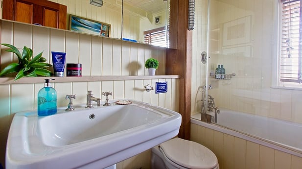 Bathroom 2: decent sized basin and a bath/shower