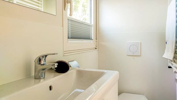 Bathroom with sink, shower and toilet.