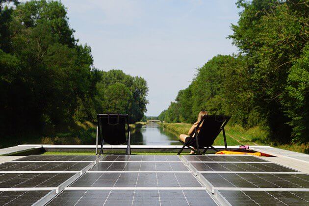 Solar panels collect energy for this houseboat