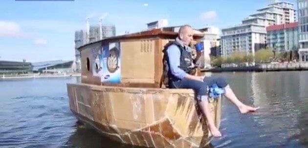 The crew and camerateam driving the cardboard houseboat.